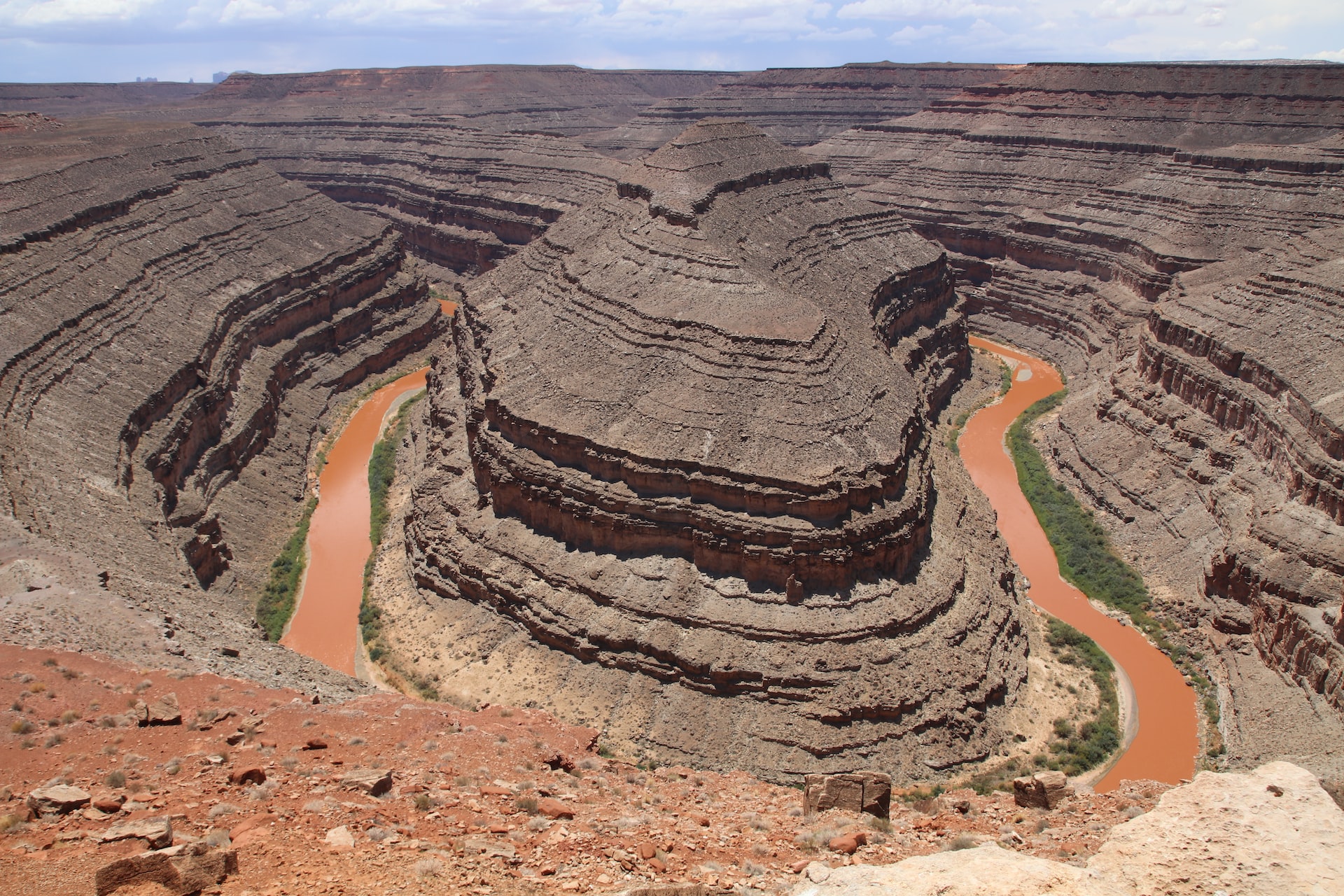 Photo of the brown San Juan River winding through a desert canyon in Utah.